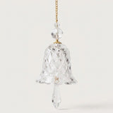 A clear bell-shaped glass suncatcher with a scalloped rim, two faceted beads, and a pointed drop hangs against a white background.