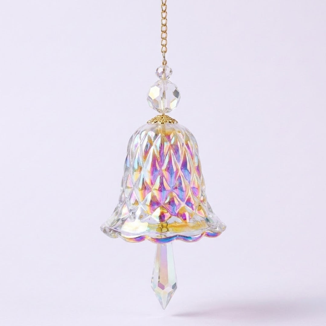 A rainbow iridescent bell-shaped glass suncatcher with clear beads and a pointed drop hangs from a gold-tone chain against a pale background.