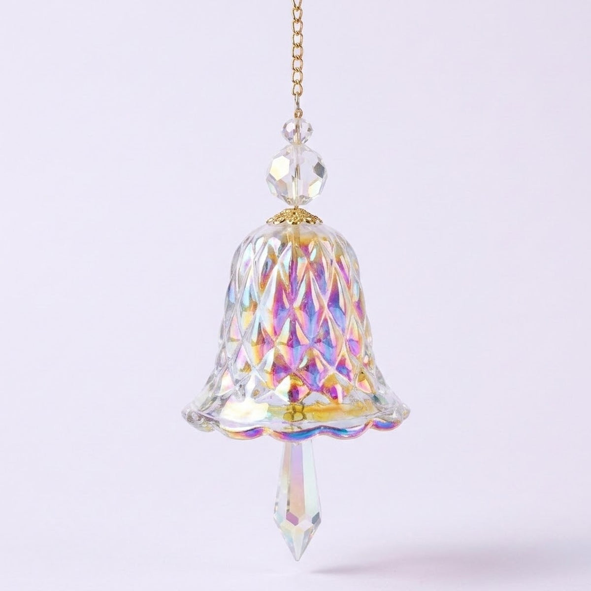 A rainbow iridescent bell-shaped glass suncatcher with clear beads and a pointed drop hangs from a gold-tone chain against a pale background.