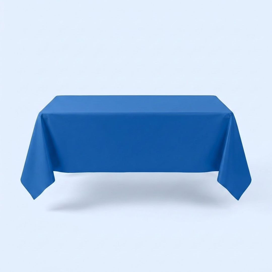 A blue tablecloth covers a rectangular table with hanging corners against a pale blue background.