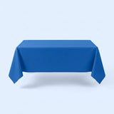 A blue tablecloth covers a rectangular table with hanging corners against a pale blue background.