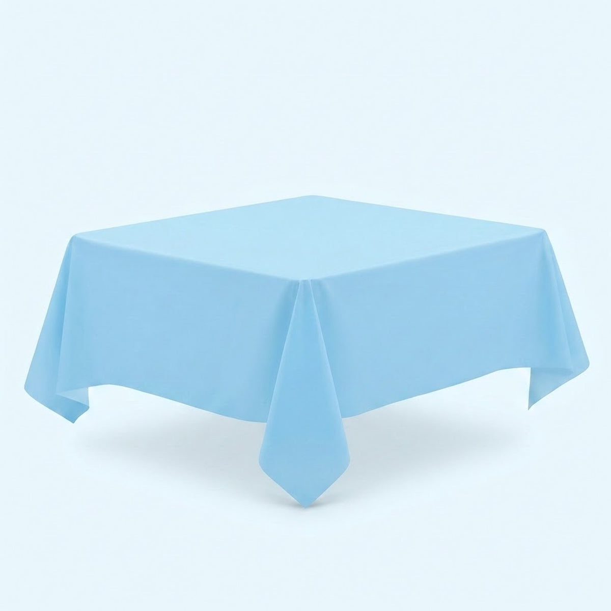 A light blue tablecloth covers a table viewed diagonally, with a pointed front corner against a pale blue background.