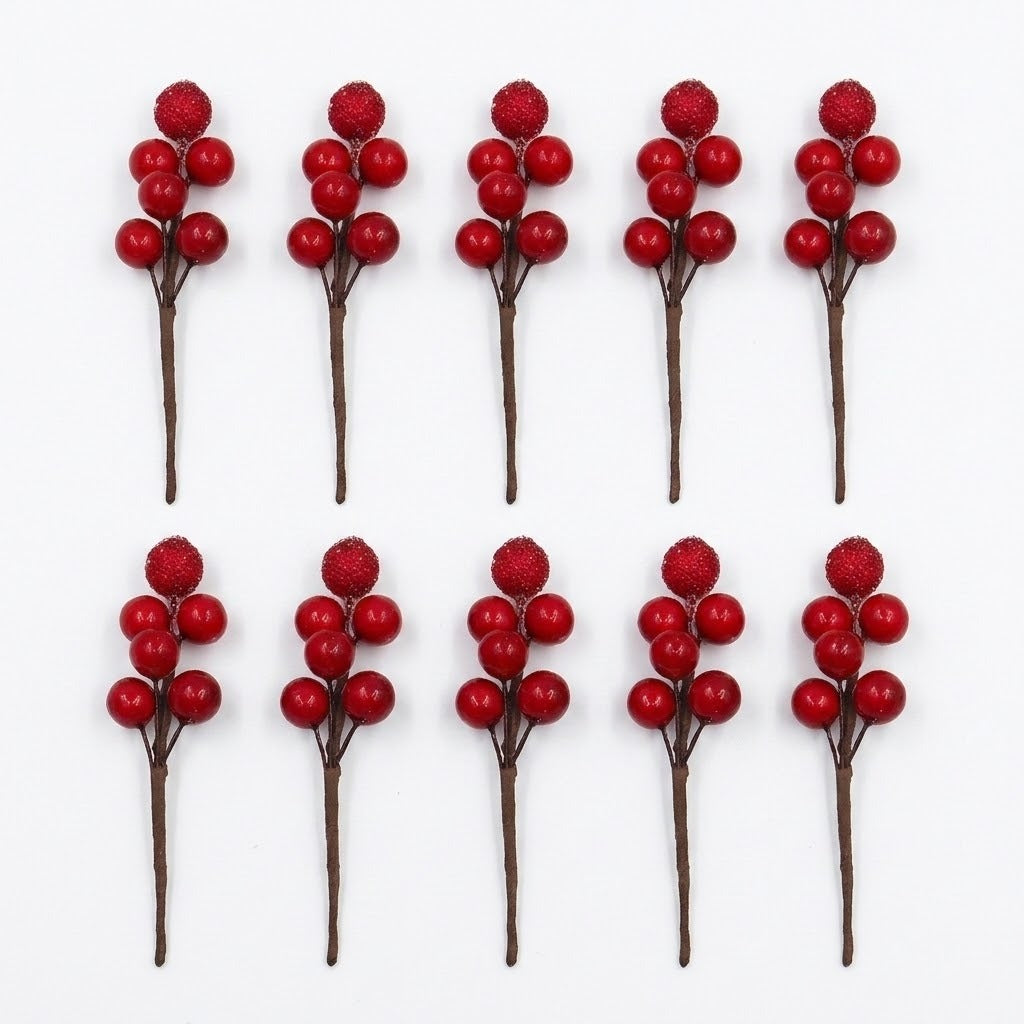 Ten red berry picks with brown stems and glittered top berries form two rows on a white background.