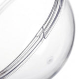 A clear plastic fillable ornament half appears close up, showing its curved joining rim against a white background.