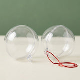 Two clear plastic fillable ornaments rest on a cream surface against a green background, one with a red hanging cord.