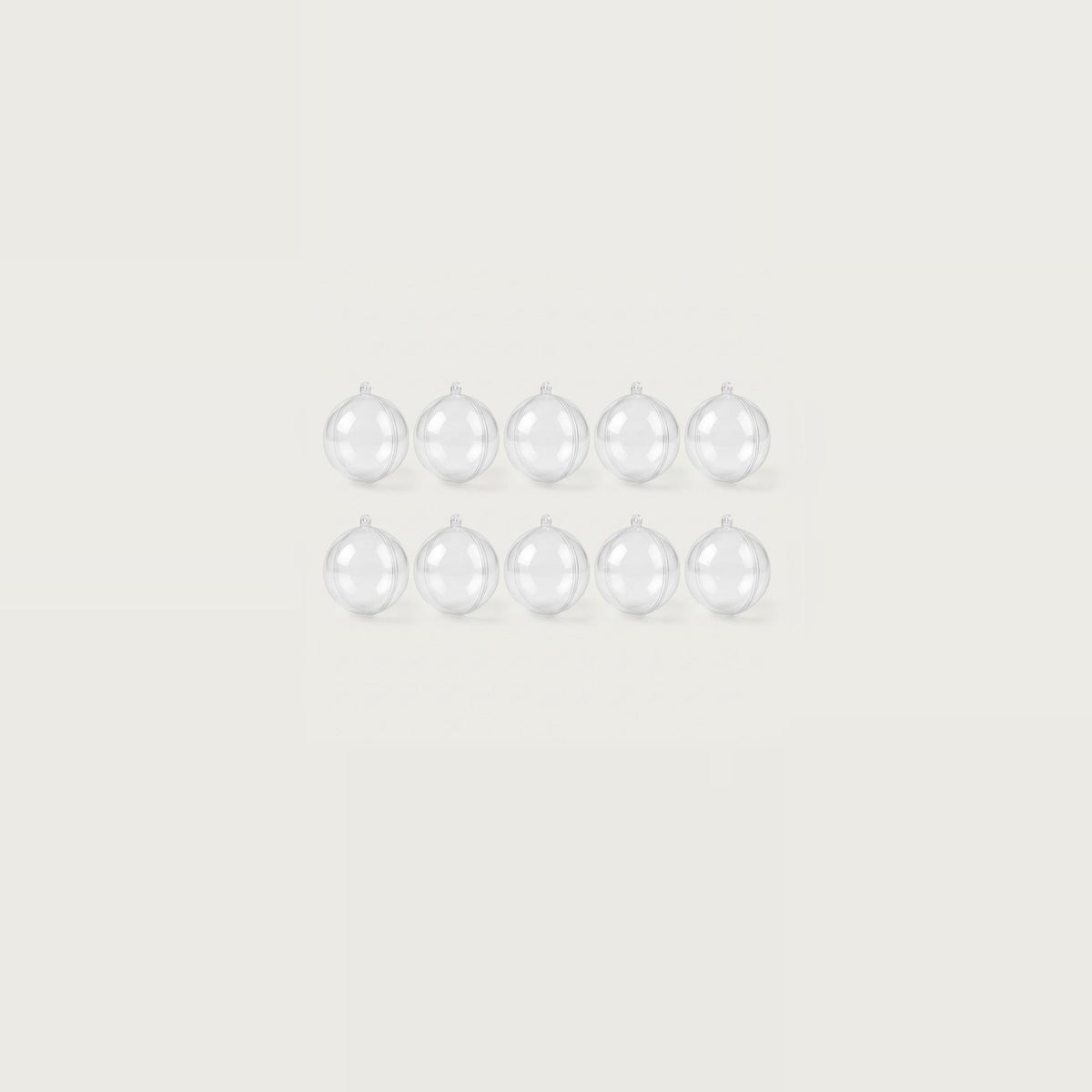Ten clear plastic fillable ornaments form two compact rows of five, centered within a wide off-white background.