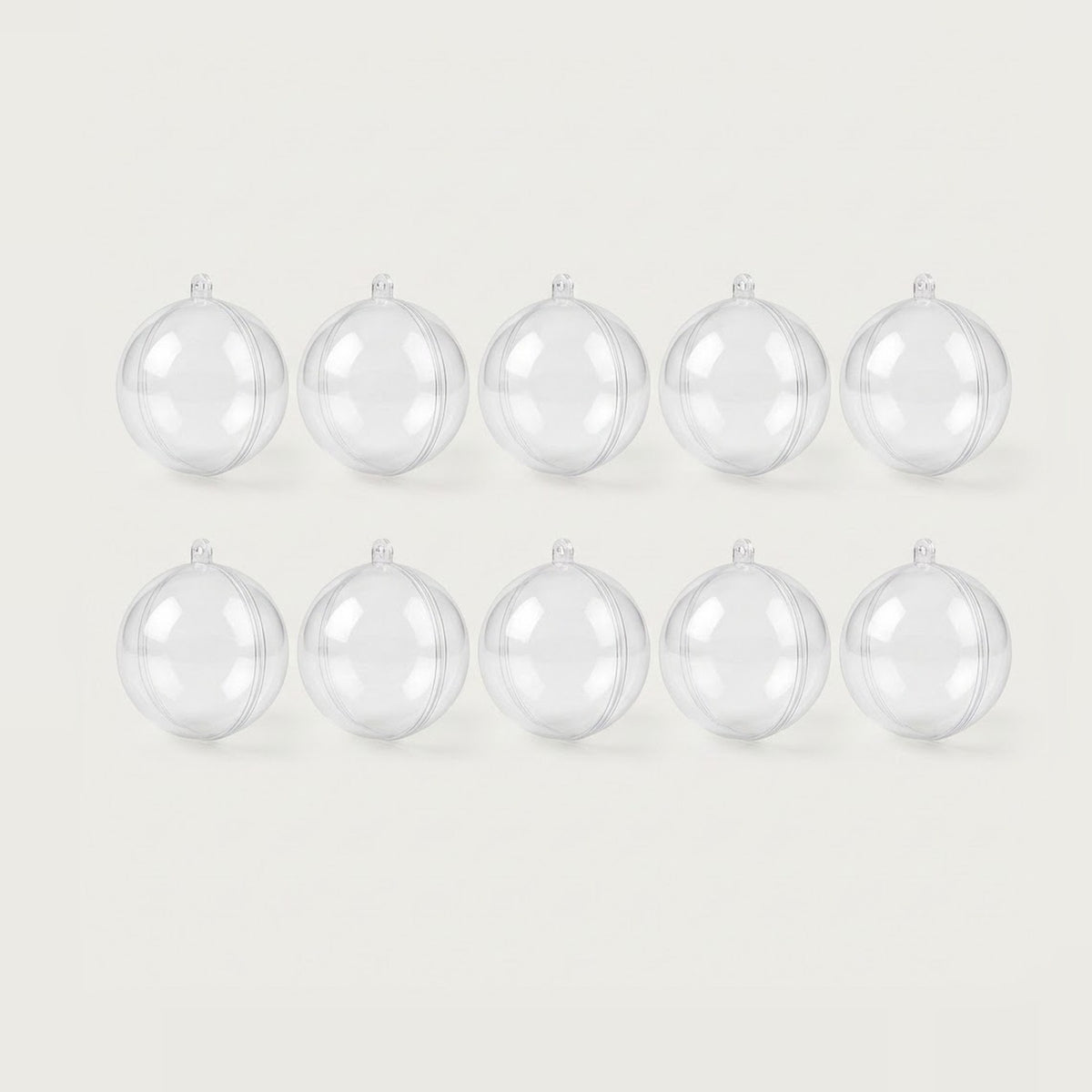 Ten clear plastic fillable ornaments with hanging loops and visible seams form two rows of five against an off-white background.