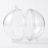 A clear plastic fillable ornament separates into two halves, displaying circular joining rims and hanging tabs against white.