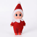 A Christmas elf doll wears a red fabric suit and pointed hat with white trim against a plain white background.