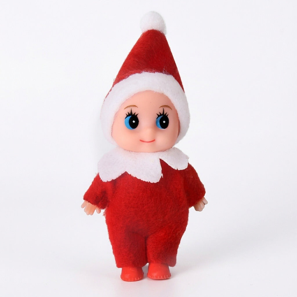 A Christmas elf doll wears a red fabric suit and pointed hat with white trim against a plain white background.