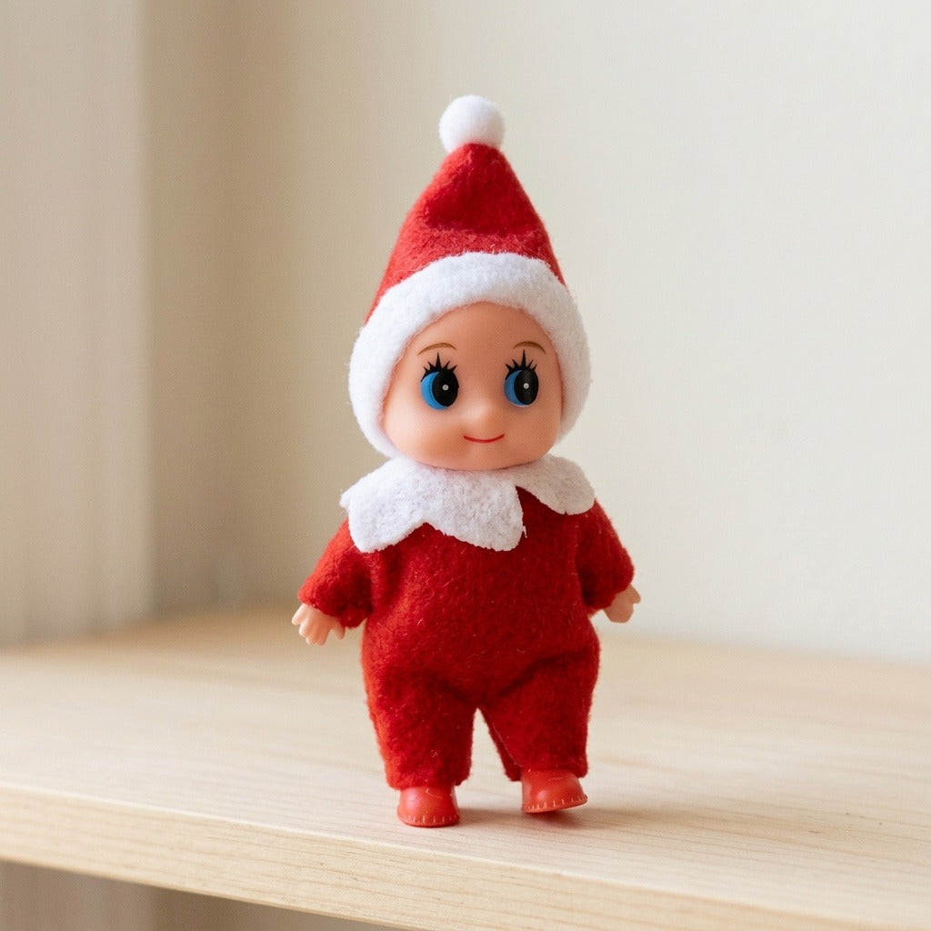 A red Christmas elf doll with a white pompom hat stands on a pale wooden shelf against a softly blurred beige background.