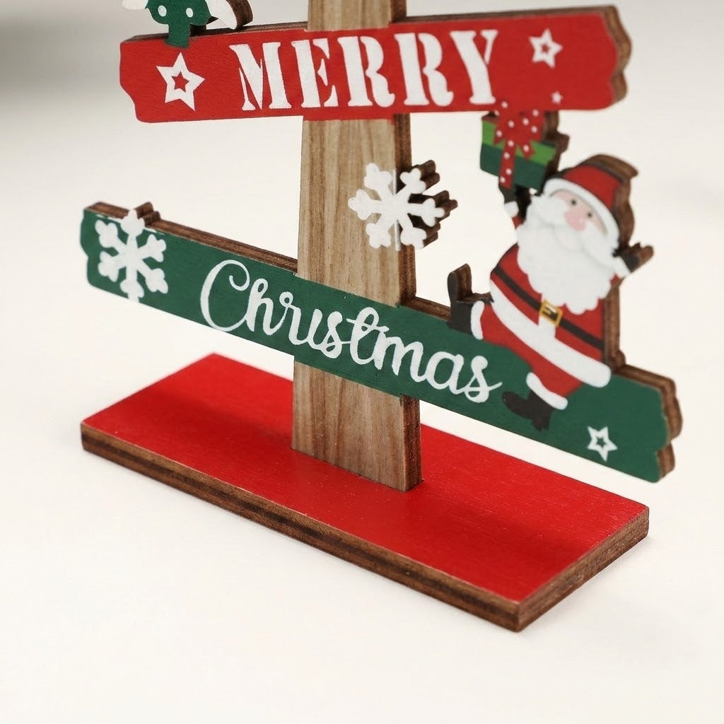 Close-up of the wooden tabletop Christmas decoration shows red and green Merry Christmas slats, a Santa cutout and red base against white.
