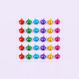 Red, green, blue, purple, gold, and pink metallic jingle bells sit in five rows of six on a pale background.
