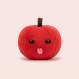 Red plush apple keychain with a brown stem, shiny black eyes, and pink tongue sits against a pale pink background.