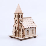 A light wooden Christmas house with a pointed tower, star cutouts, and tree silhouettes stands against a white background.