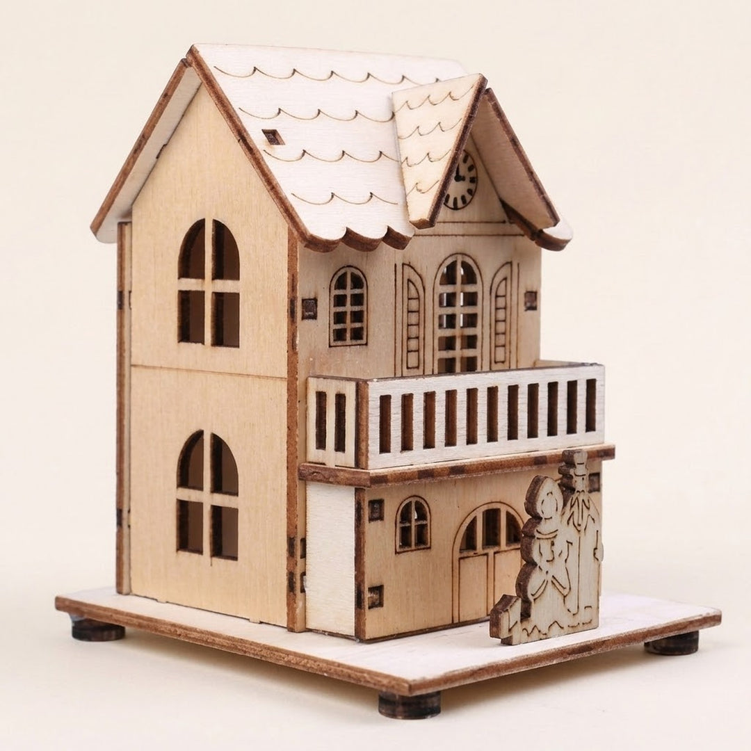 A pale wooden Christmas house with a balcony, arched windows, and two snowman figures stands against a cream background.