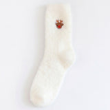 A single fluffy off-white sock with a small embroidered reindeer motif near the cuff, shown against a plain white background.
