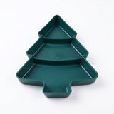 An empty dark green Christmas tree serving tray displays three compartments and raised edges against a white background.