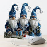 A blue Christmas gnome tabletop decoration on a clear oval base stands beside a gray computer mouse against a white background.