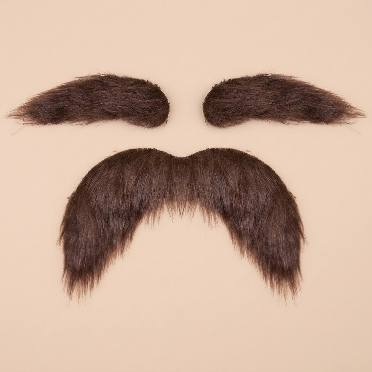 Brown costume facial hair set with two eyebrows above a thick, drooping mustache on a pale peach background.