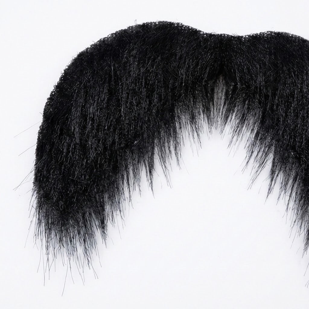 Black costume facial hair appears in close-up, showing dense mustache fibers and tapered downward ends against a white background.