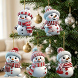 Five white snowman ornaments wearing red and white hats and scarves hang among green Christmas tree branches and metallic baubles.