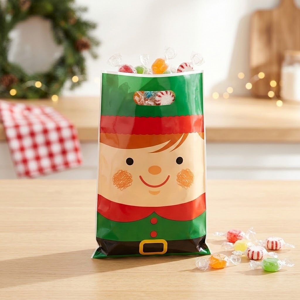 Green and red elf gift bag filled with wrapped candies on a wooden counter, with a blurred Christmas wreath behind.