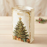Open cream gift bag with a green Christmas tree print and oval handle stands on a wooden table beside a berry sprig.