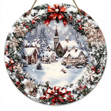 Round wood Christmas sign against a white background features a rope hanger and flat winter village artwork bordered by printed greenery.