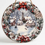 Round wood Christmas sign with a rope hanger displays snowy village artwork, printed red bows, and snowflakes against a pale background.