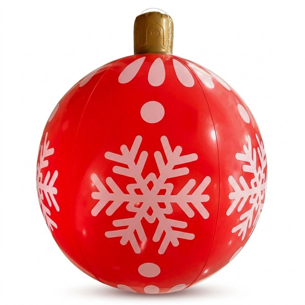A red PVC inflatable ornament with white snowflakes, dots, visible panel seams, and a gold top stands against a white background.