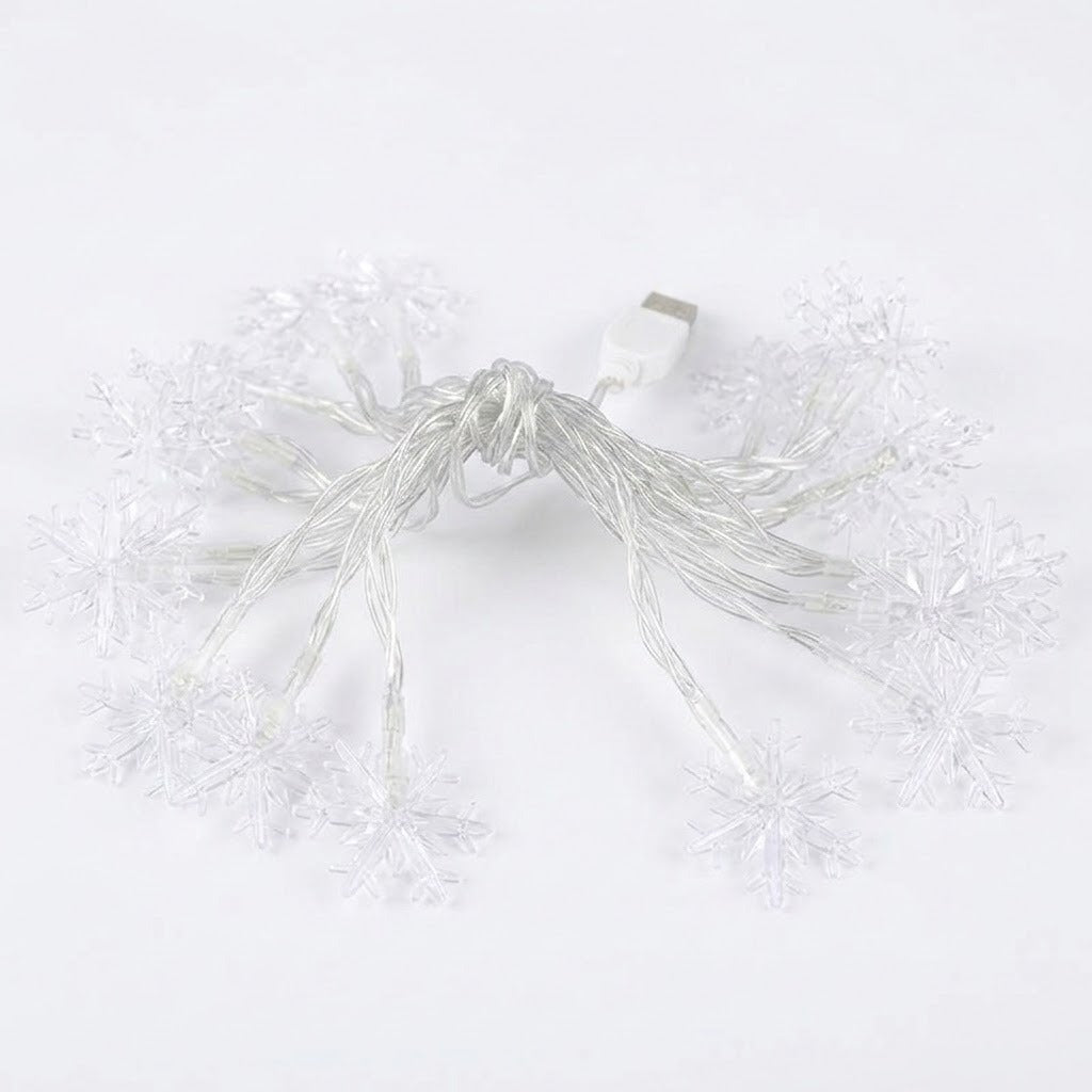 White USB snowflake string lights with clear plastic snowflake-shaped bulbs on a plain white background.