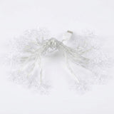 White USB snowflake string lights with clear plastic snowflake-shaped bulbs on a plain white background.