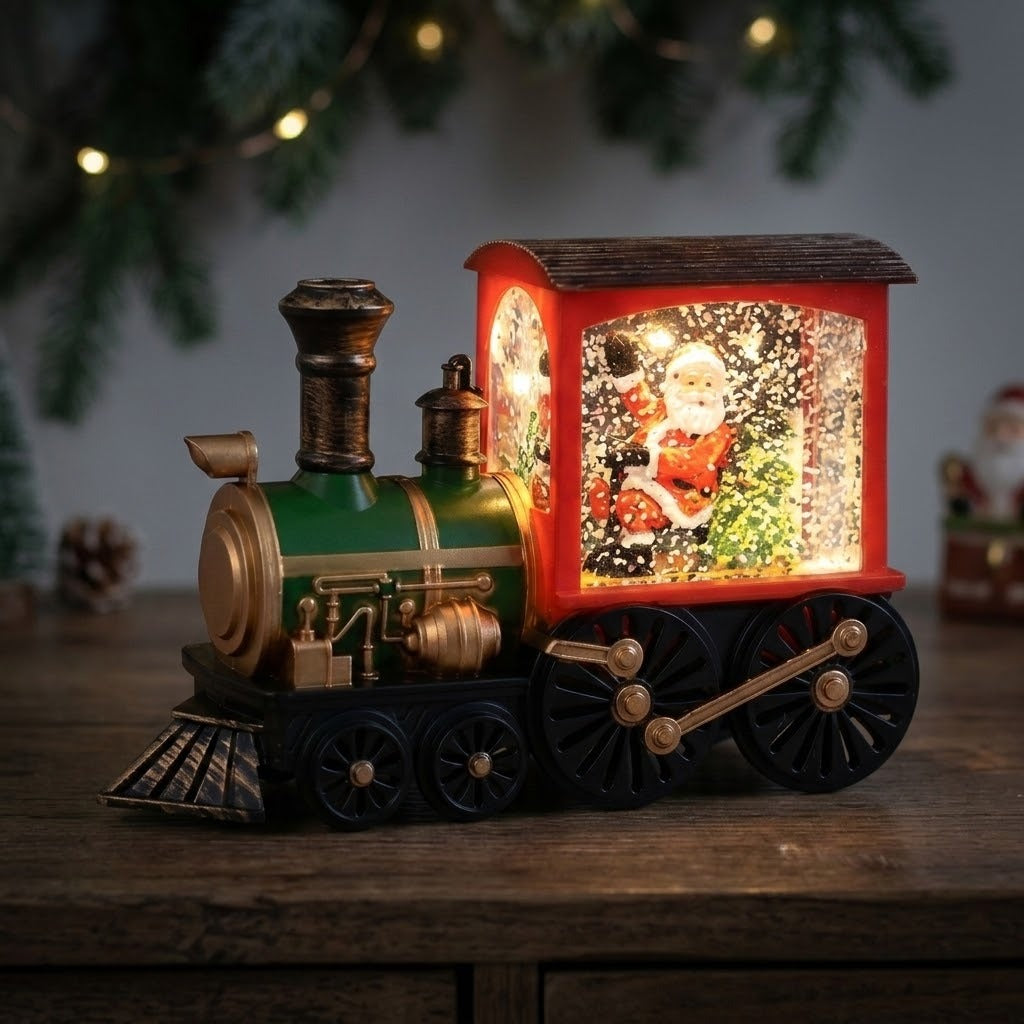 Red and green Christmas train decoration displays an illuminated Santa scene with white flecks on a dark wooden cabinet beneath evergreen garland.