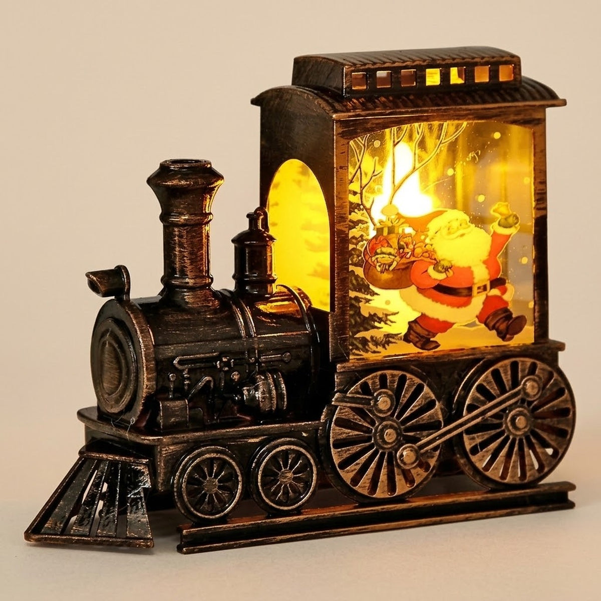 Bronze-tone plastic Christmas train decoration features a yellow-lit Santa illustration and detailed wheels against a beige background.