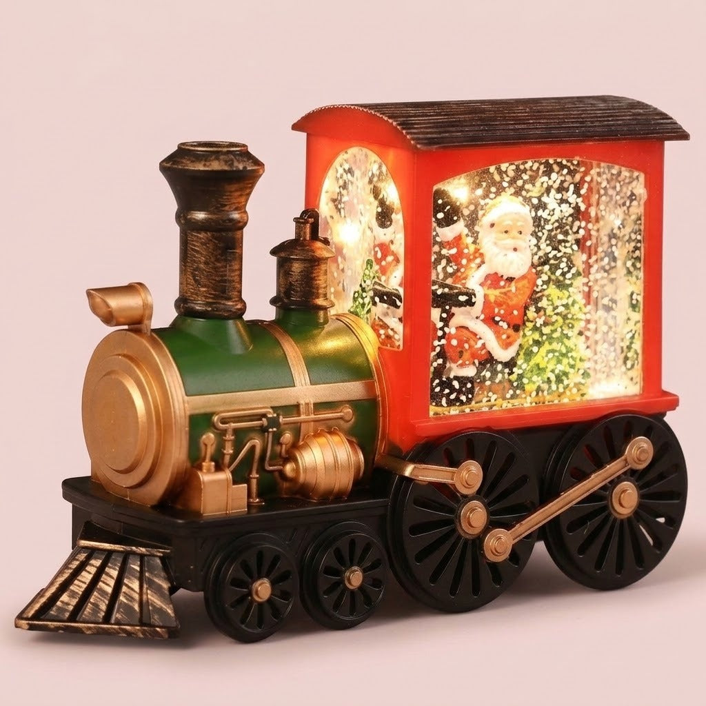 Lighted red and green Christmas train decoration with black wheels showing Santa and glowing snow-like flecks inside the cab.