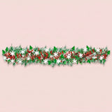 Green, red, and silver tinsel garland with green tree shapes and white snowflakes stretches horizontally across a pale pink background.