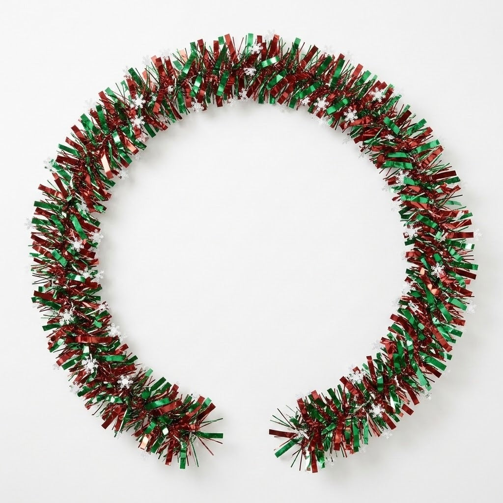 Red and green tinsel garland with white snowflakes curves into an open circle on a white background.