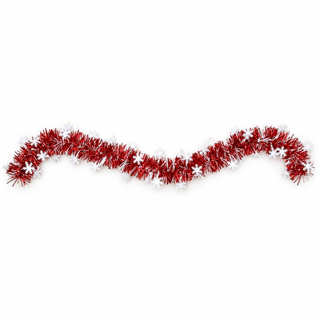 Red tinsel garland with white snowflakes lies in a gentle wave across a white background.