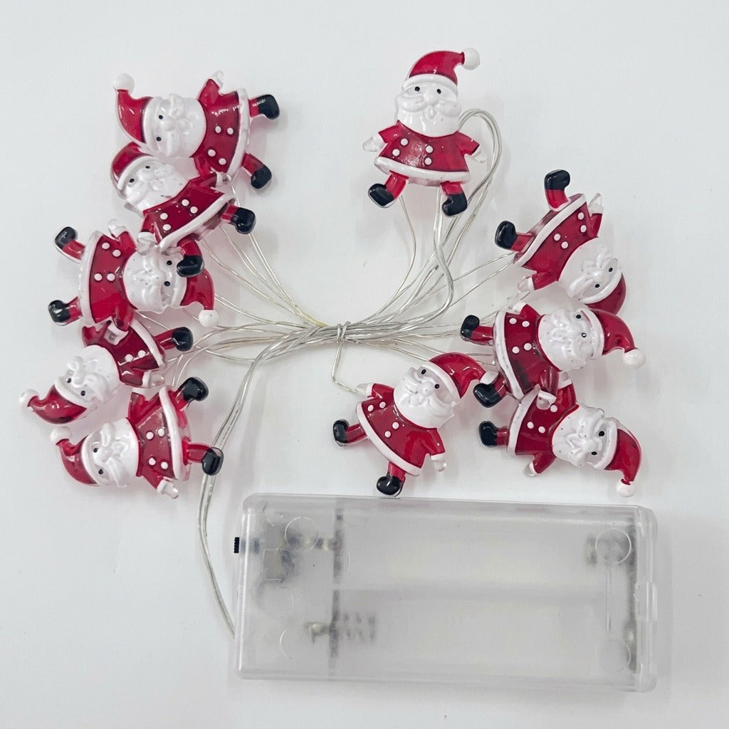 Unlit red and white Santa string lights connect to an empty transparent battery box on a white background.