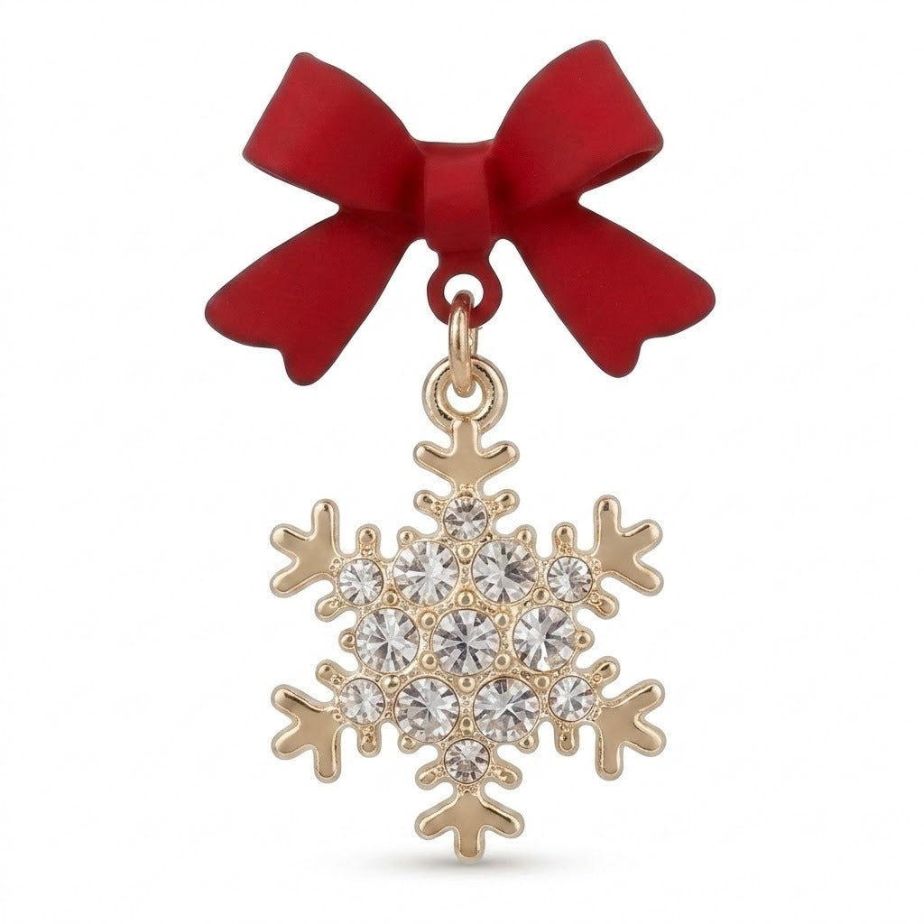 A red bow earring with a gold-tone snowflake drop and round clear stones stands against a white background.