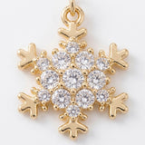 A snowflake drop earring detail shows clear round rhinestones and gold-colored outlines against a white background.