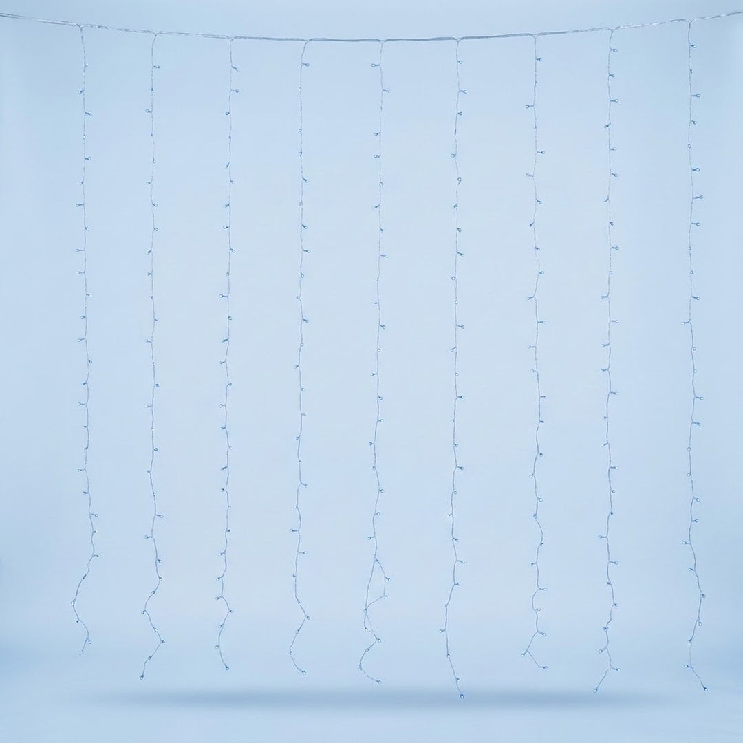 Blue curtain lights hang in spaced vertical strands from a clear cable against a pale blue background.
