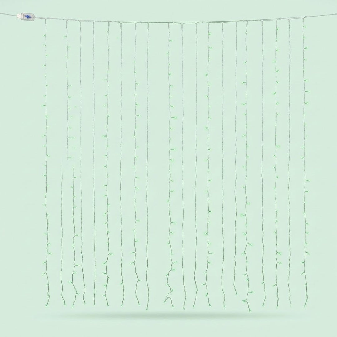 Green curtain lights hang in vertical strands against a pale green background, with a USB connector at the upper left.
