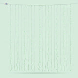 Green curtain lights hang in vertical strands against a pale green background, with a USB connector at the upper left.