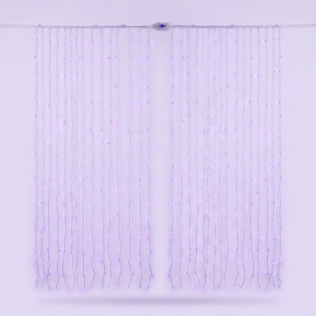 Pale purple curtain lights hang on clear wires against a lavender background, with a small connector along the top cable.