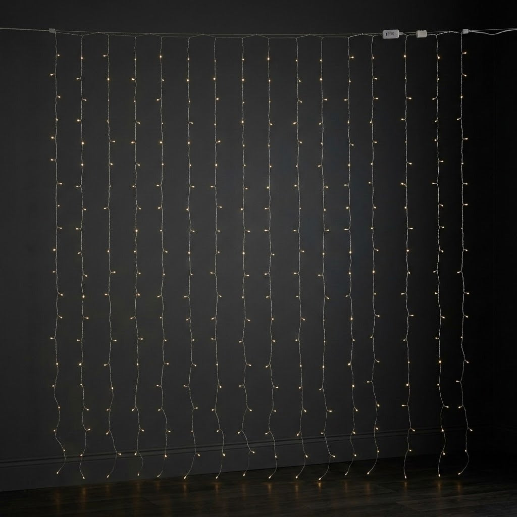 Small white curtain lights hang against a dark wall, with clear wiring and inline connectors visible along the top.