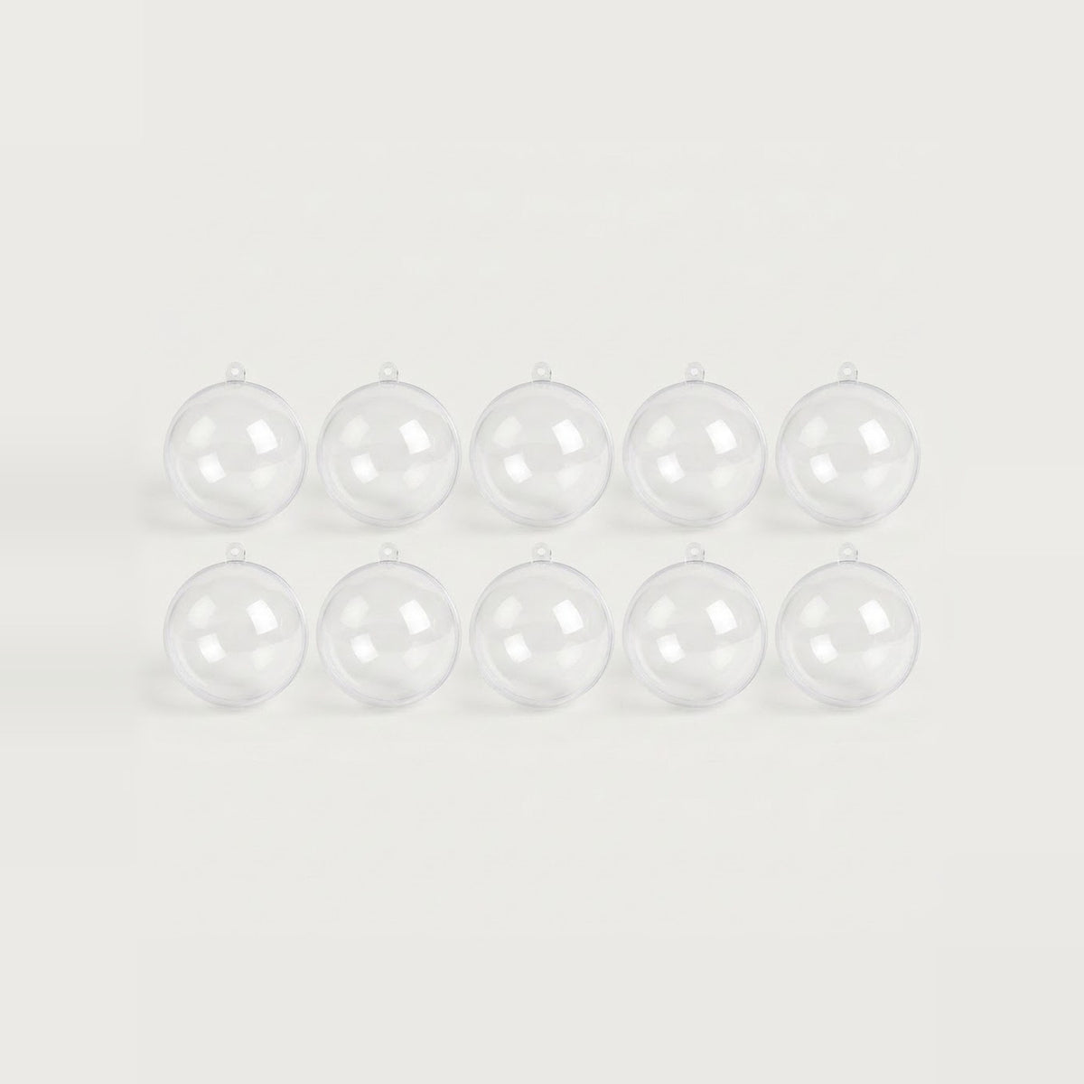 Ten clear plastic fillable ornaments with hanging loops sit in two evenly spaced rows against a white background.