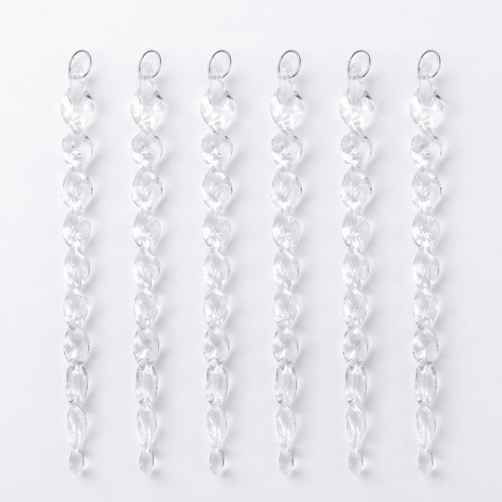 Six clear acrylic Christmas ornaments shaped like twisted icicles lie side by side with silver hanging loops against a white background.