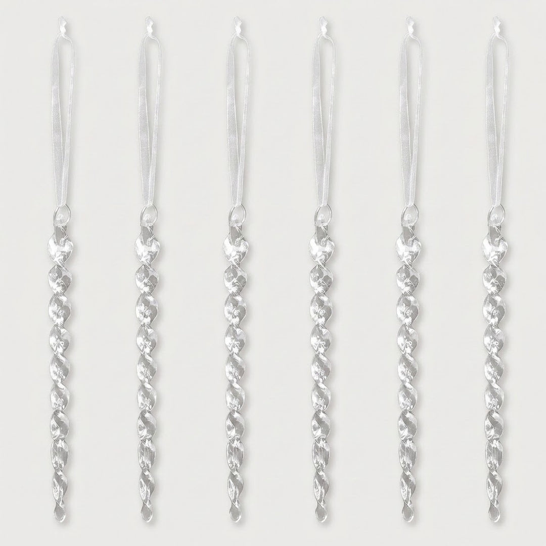 Six clear acrylic twisted icicle Christmas ornaments with white hanging ribbons are evenly spaced against a white background.